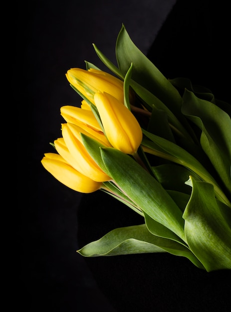 Top view yellow tulips on table