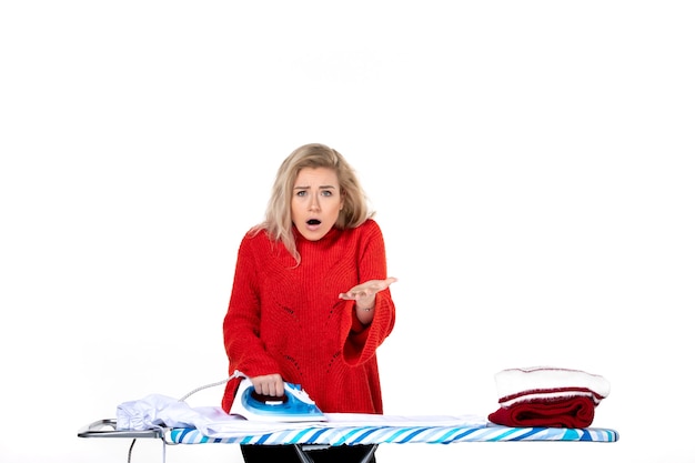 Top view of young beautiful woman ironing clothes wondering something on white background