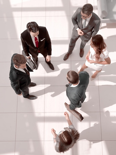 Top viewa group of business people standing on a marble floor