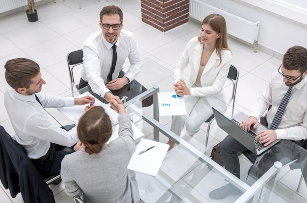 Top viewhandshake business partners at the negotiating table