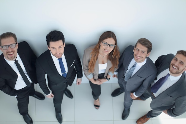 Vista dall'altogruppo professionale di affari che esamina la macchina fotograficail concetto di lavoro di squadra