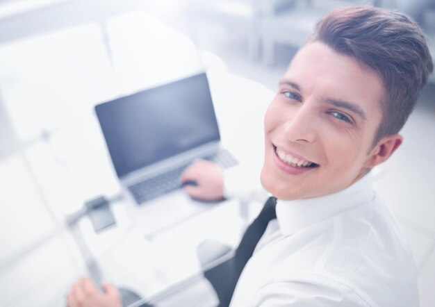 Top viewsmiling businessman sitting at his desk