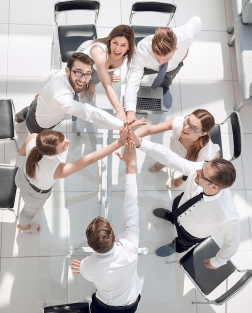 Top viewthe company's employees are giving each other high fivethe concept of teamwork