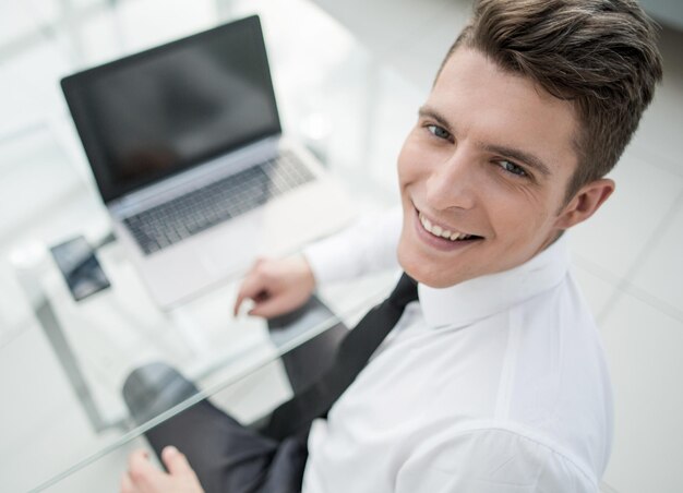 Top viewyoung businessman sitting at his desk