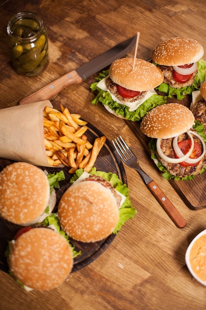 Top virew of burgres with lettuce on a cutting board. Fast food. Classic cheesburger.