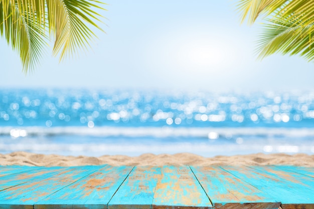 Top of wood table with seascape and palm leaves