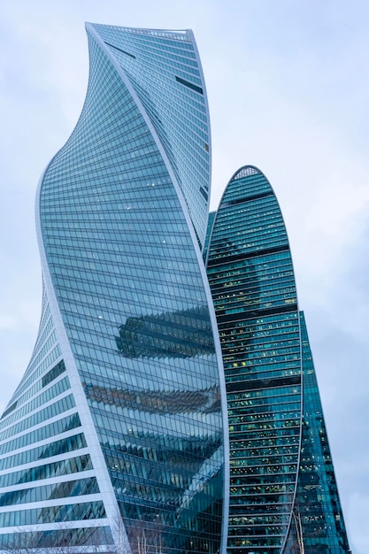 The tops of modern corporate buildings in snowfall Low angle view of skyscrapers