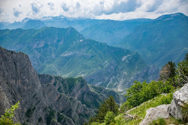 The tops of the picturesque mountains are covered with white snow