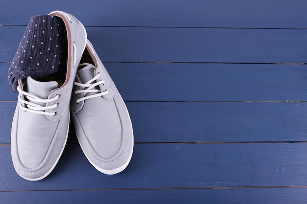 TopSiders and pair of socks on dark blue wooden background