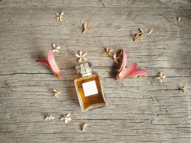 Photo topview of square blank fragrance bottle on brown wood background.