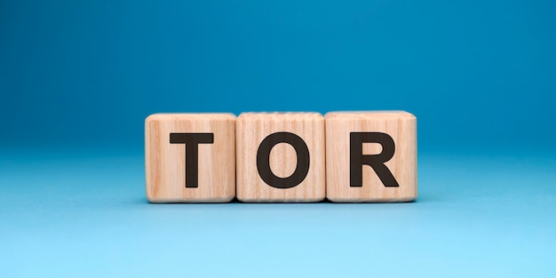 TOR word cube on a blue surface. Business concept.