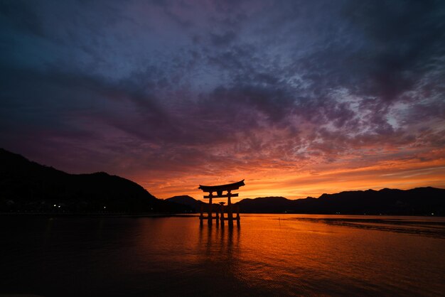 写真 雲の空を背景にイツクシマ神社にあるトリーゲート