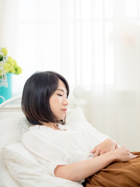 Tormented young woman in her bedroom