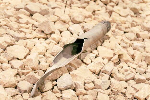 A torn artillery shell on the stone ground.