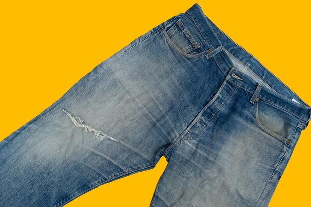 Torn blue mens jeans denim pants isolated on background fashion clothing concept view from above