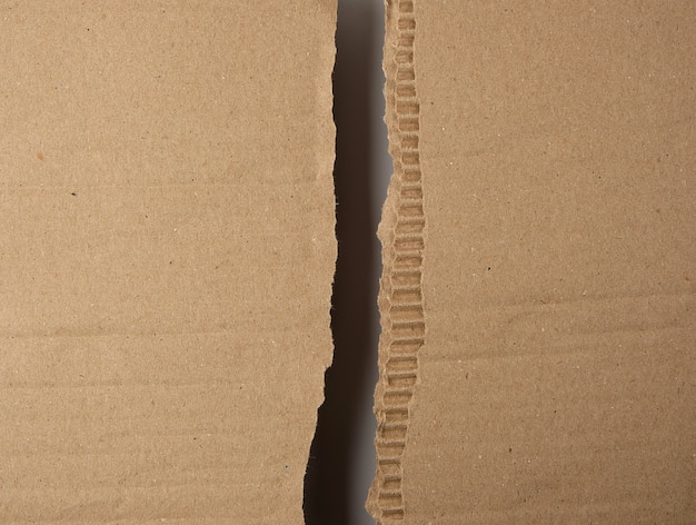 Torn in half brown sheet of paper from under the box