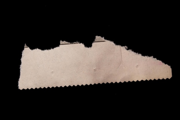 Foto pezzo di giornale strappato isolato su sfondo nero. carta strappata.