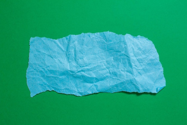 A torn piece of paper is shown on a green background.