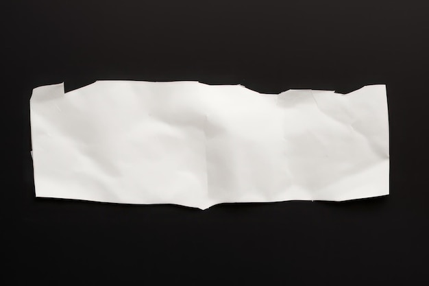 Torn white paper on the black background empty tet space background