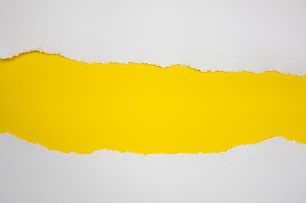 Torn white stripes on a yellow background Copy space