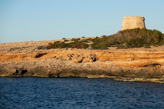 The Torre den Rovira is located in front of the western islets between the beaches of Comte and Cal