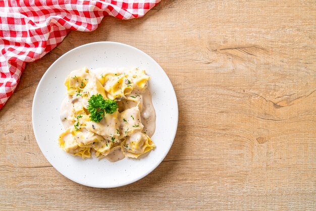 tortellini pasta with mushroom cream sauce and cheese