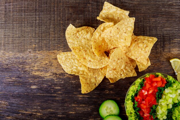 Tortilla chips, avocado dip, tomato and cucumber