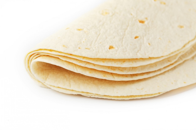 Tortilla . Corn tortilla or simply tortilla is a type of thin unleavened bread made from Hominy.