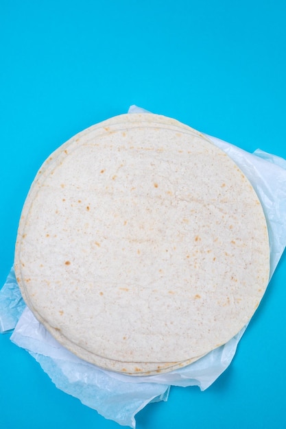 Tortilla on white paper on blue