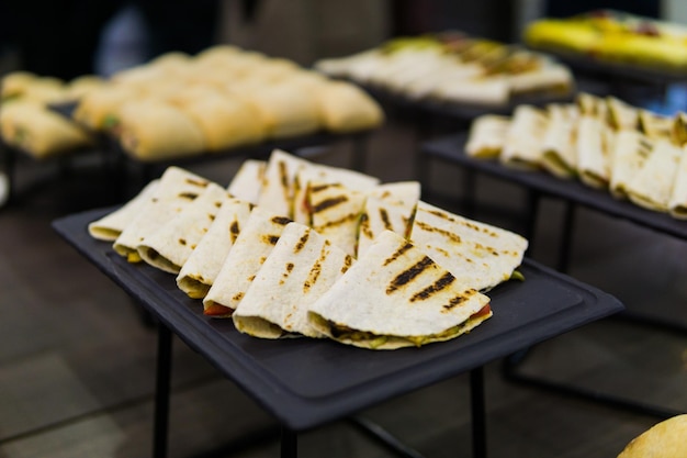 Tortilla with filling on a tray for catering