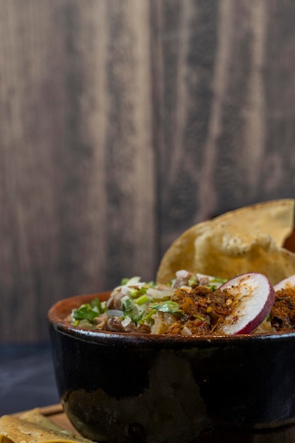 Tostadas carne typical mexican food wooden plate and wooden bottom radish and onion