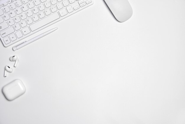 Total white workplace table with mouse keyboard headphones