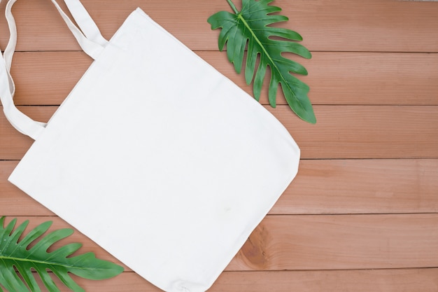 Tote bag canvas fabric cloth shopping sack mockup blank on wood backgroung.