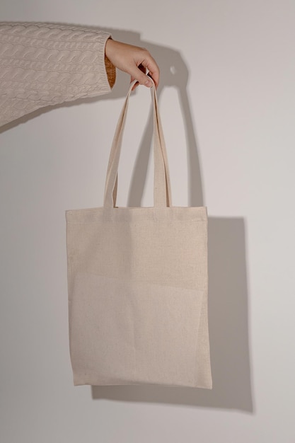 Tote bag mock up in hand of woman in sweater eco bag mockup