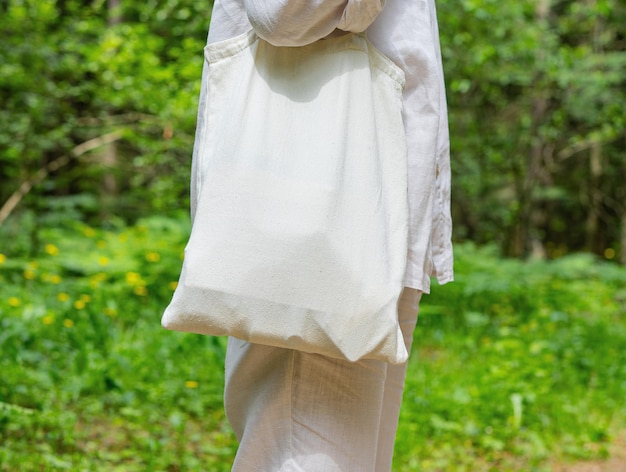 Tote canvas bag mockup shoulder pack from natural linen fabric textile nature background