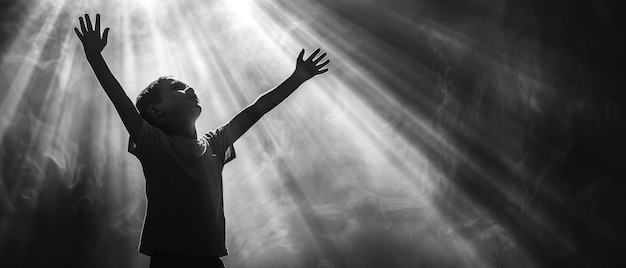 Photo touching the divine a black and white childs ascension day in the shadows