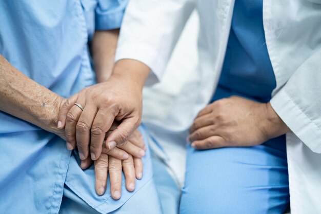 Touching hands Asian senior woman patient with love