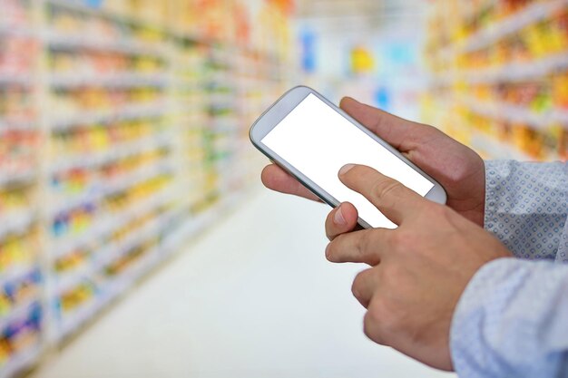 Touchscreen shopping on mobile phone. Internet ordering buying telecommunication payment. Man checking shopping list on her smartphone at supermarket.