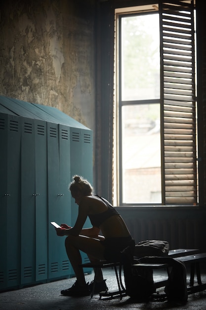 Tough Sportswoman using Smartphone