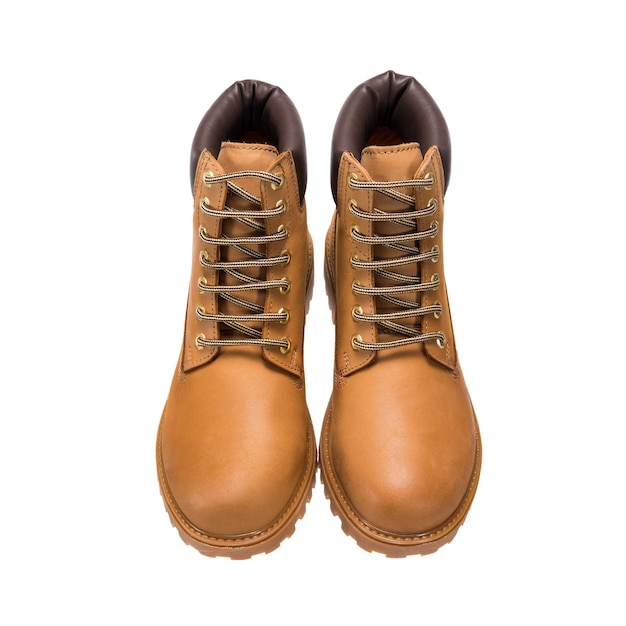 Touring light brown boots with lace-up tread isolated on a white surface