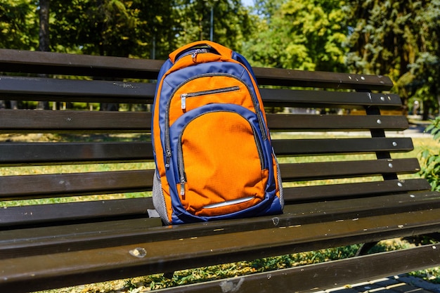 Tourist backpack on a bench in city park