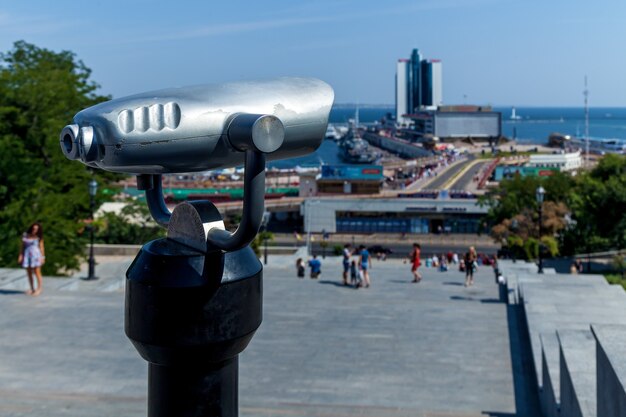 The tourist binocular pointing out to the seashore on a sunny day. Amazing landscape of the coastal city in Odessa.
