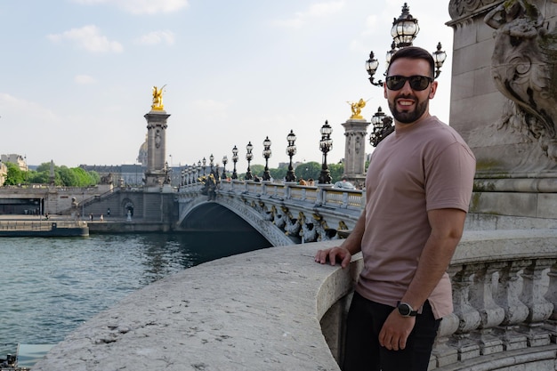 Tourist boy on the Alexander III bridge