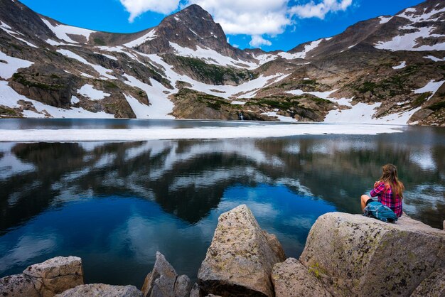 Tourist in colorado hiker girl rests at blue lake