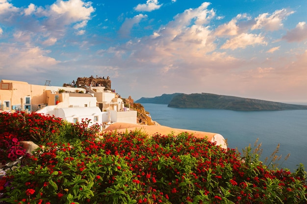 Tourist crowd gathered to watch the sunset in oia village santorini island greece