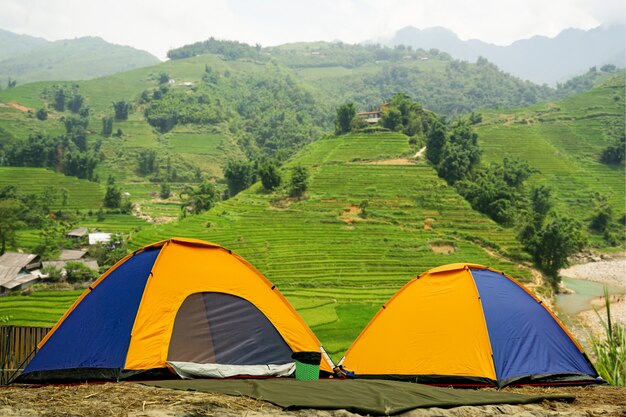 Tourist dome tent camping  in forest camping on mountain background