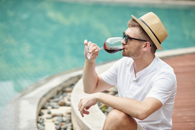 Tourist drinking wine at resort