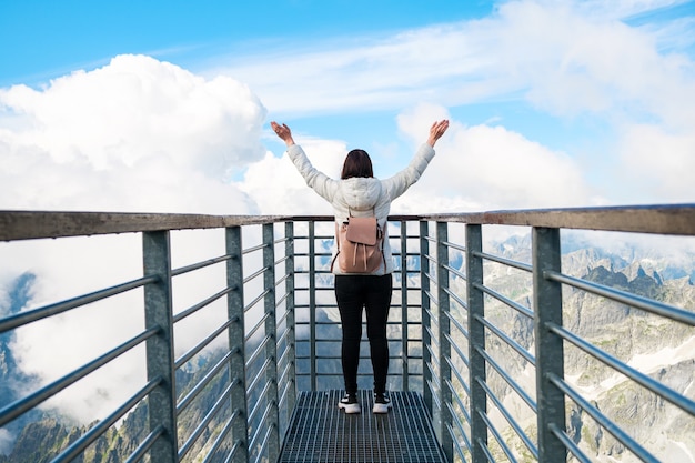 Tourist enjoying of amazing view of mountains and clouds view from lomnicky peak in slovakia sport