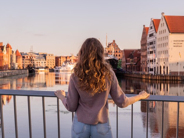 Tourist exploring riverside in old town, Gdansk, Poland