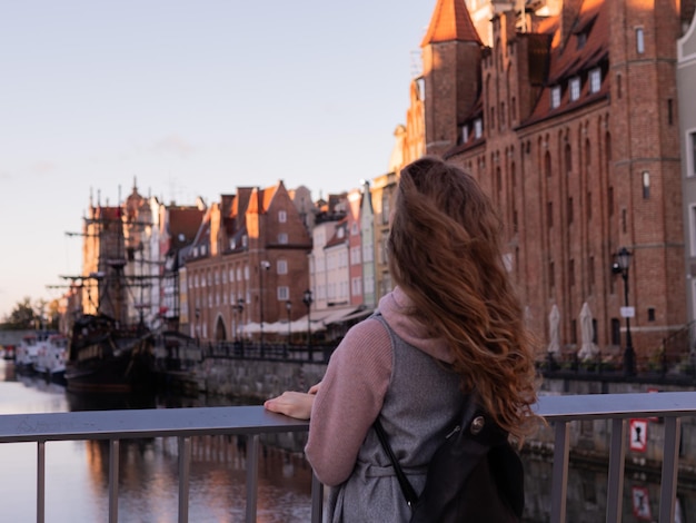 Tourist exploring riverside in old town, Gdansk, Poland